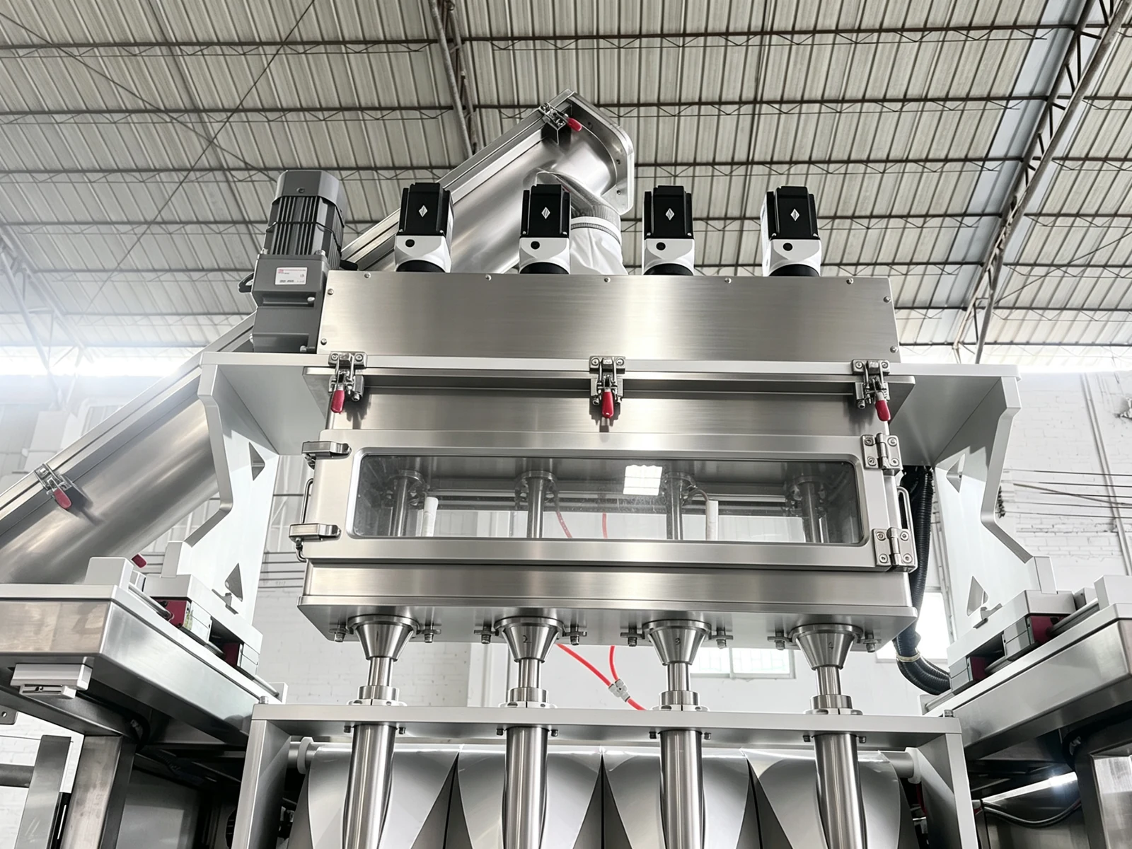 Hopper, drive assemblies and repeated filling outlets shown on the powder machine.